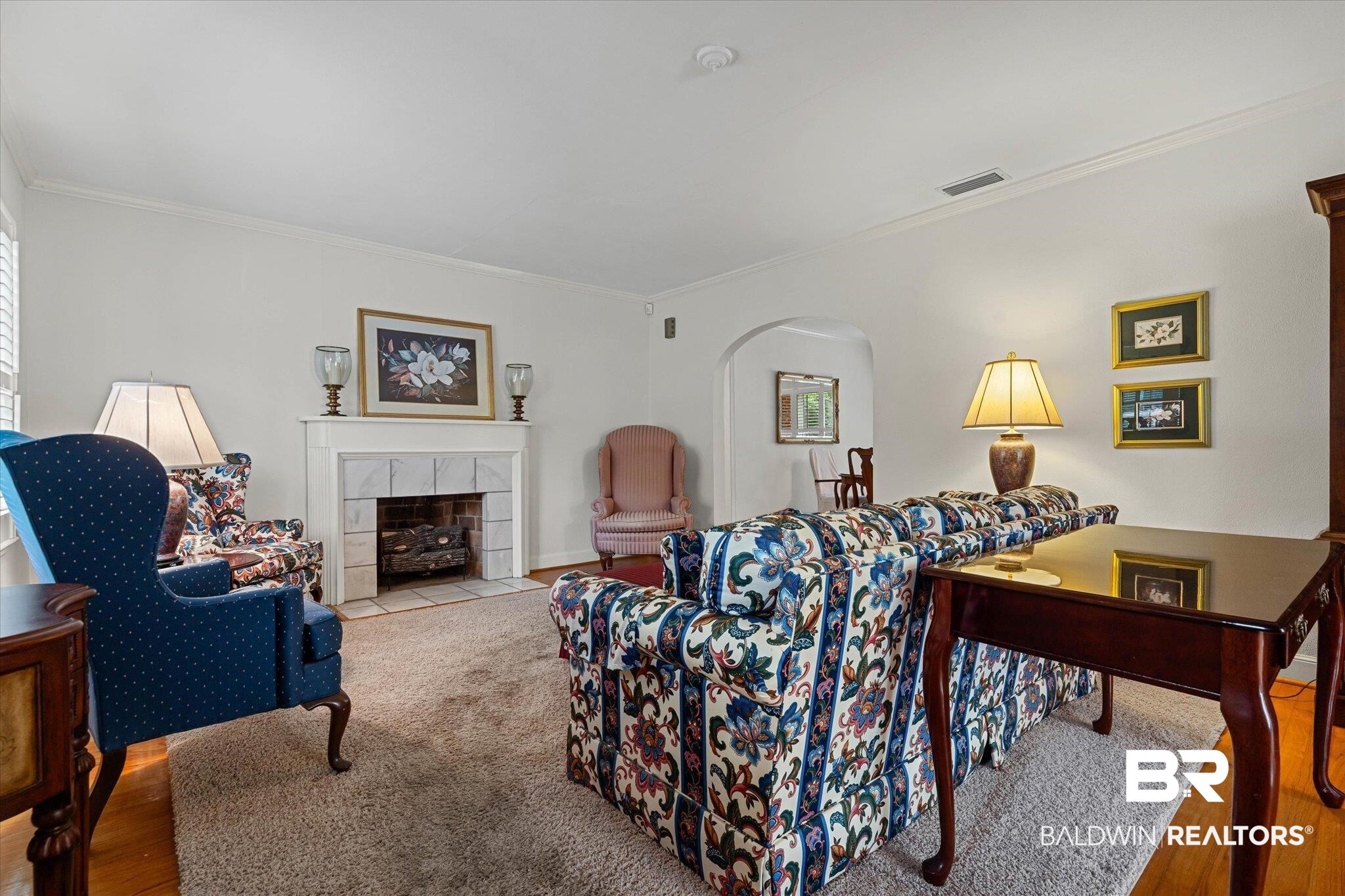 300 Woodlands Avenue Mobile, AL 36607 - Photo 2 of 23 Living room with ornamental molding, a tiled fireplace, and wood finished floors