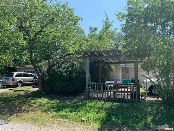a view of house with backyard