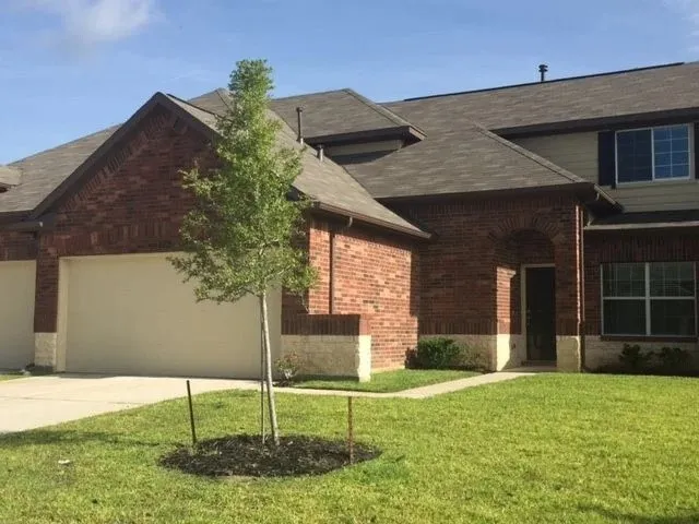 a house that has a tree in front of it