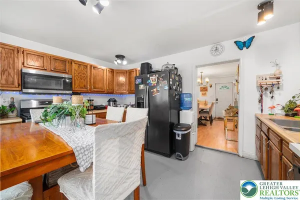 a kitchen with stainless steel appliances granite countertop a refrigerator a stove top oven a sink dishwasher and cabinets