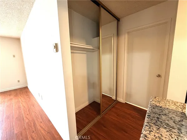 a view of bedroom with wooden floor