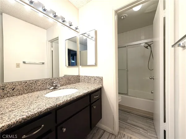 a bathroom with a granite countertop sink mirror and double
