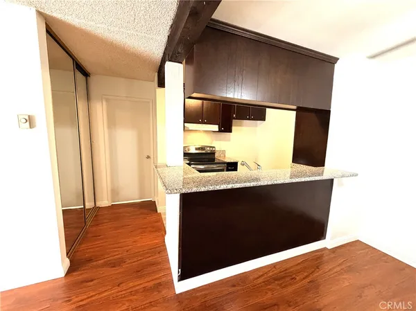 a view of a kitchen with wooden floor