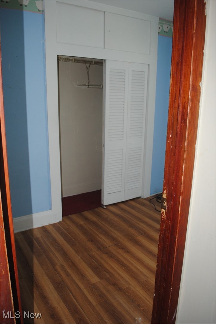 841 Whitcomb Road Cleveland, OH 44110 - Photo 16 of 30 Unfurnished bedroom featuring dark wood-style floors and a closet