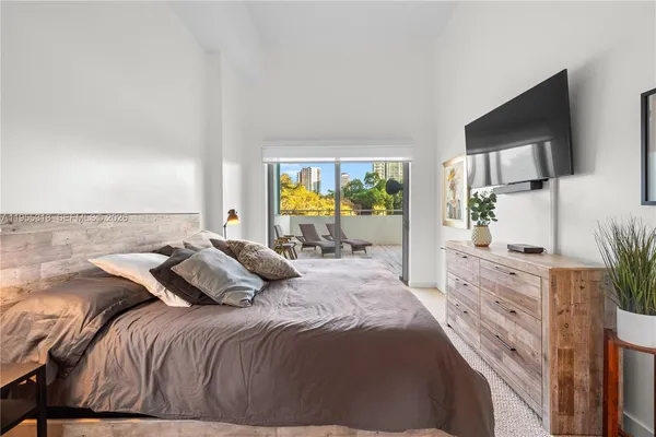 a bedroom with a bed and glass windows