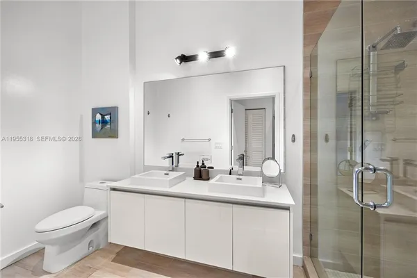 a bathroom with a sink a shower and a mirror