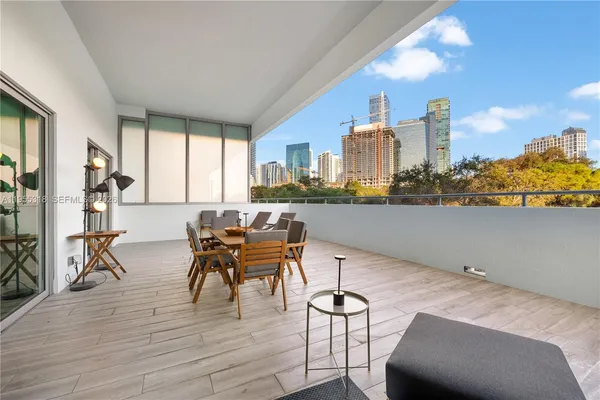 a kitchen with stainless steel appliances granite countertop a refrigerator a sink a stove top oven and cabinets