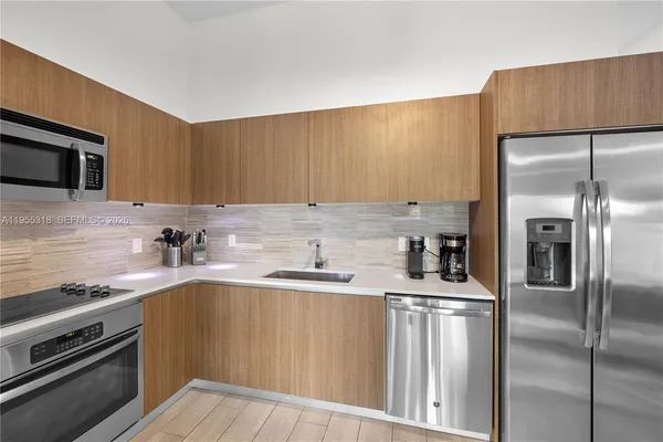 a large kitchen with cabinets and stainless steel appliances
