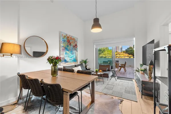 a dining room with furniture a window and a fireplace