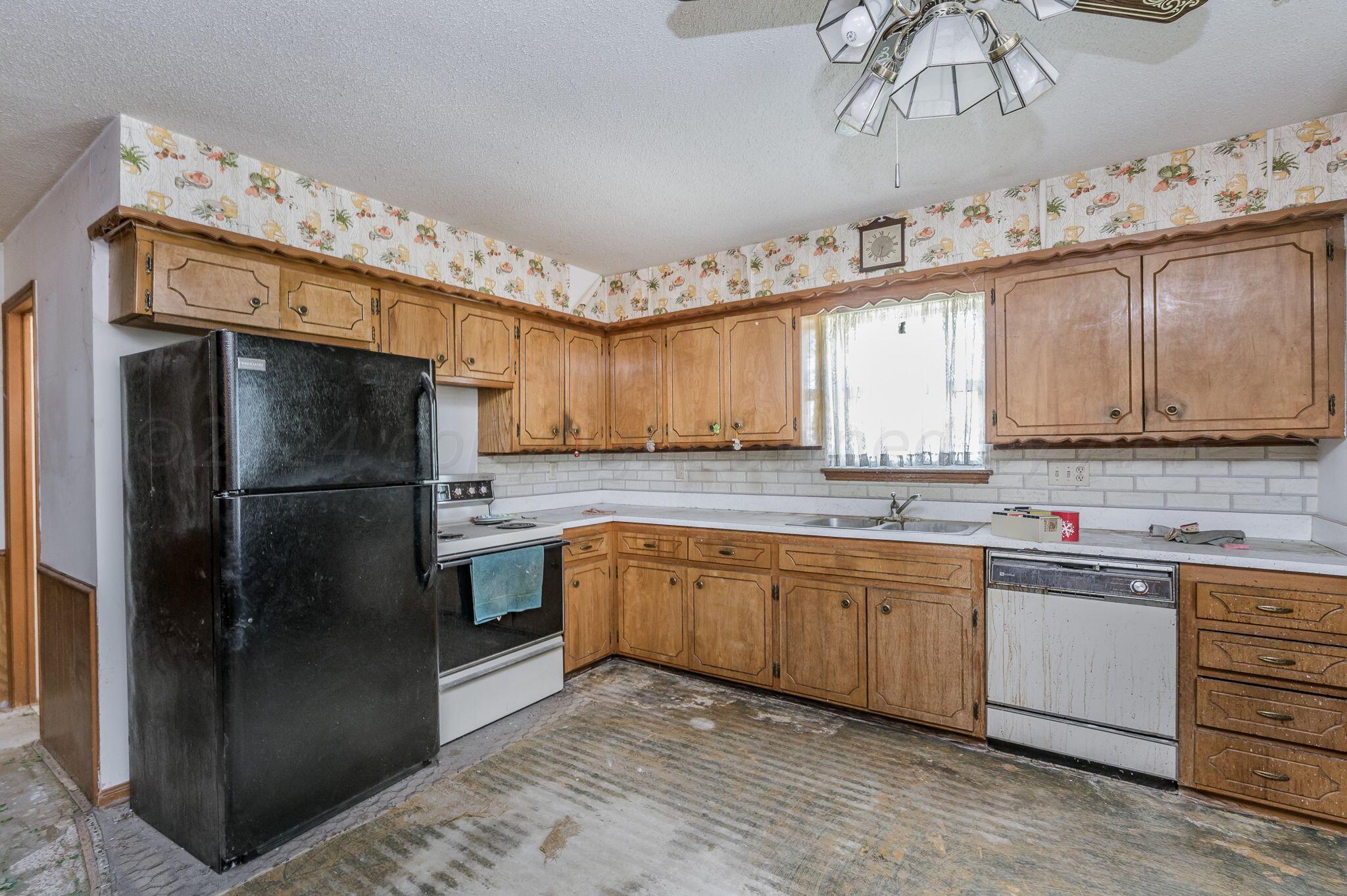 503 Cherry Avenue Dumas, TX 79029 - Photo 5 of 13 a kitchen with granite countertop stainless steel appliances a sink and cabinets