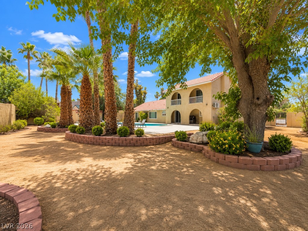 3010 East Viking Road Las Vegas, NV 89121 - Photo 42 of 48 A spacious backyard with desert landscaping, mature trees, and a refreshing pool offers a private retreat.