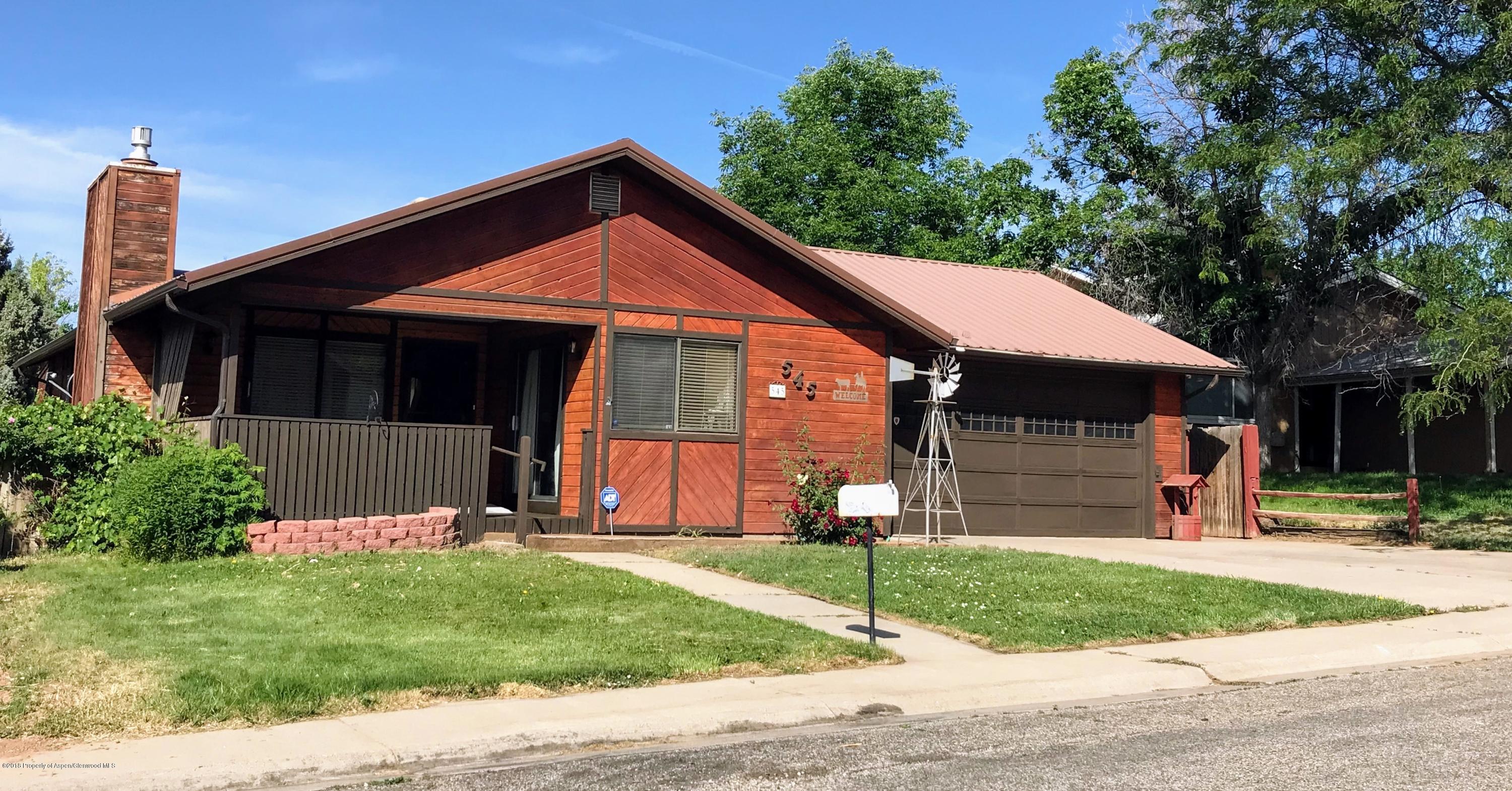 545 Ash Avenue Rifle, CO 81650 - Photo 2 of 26 a front view of a house with a yard