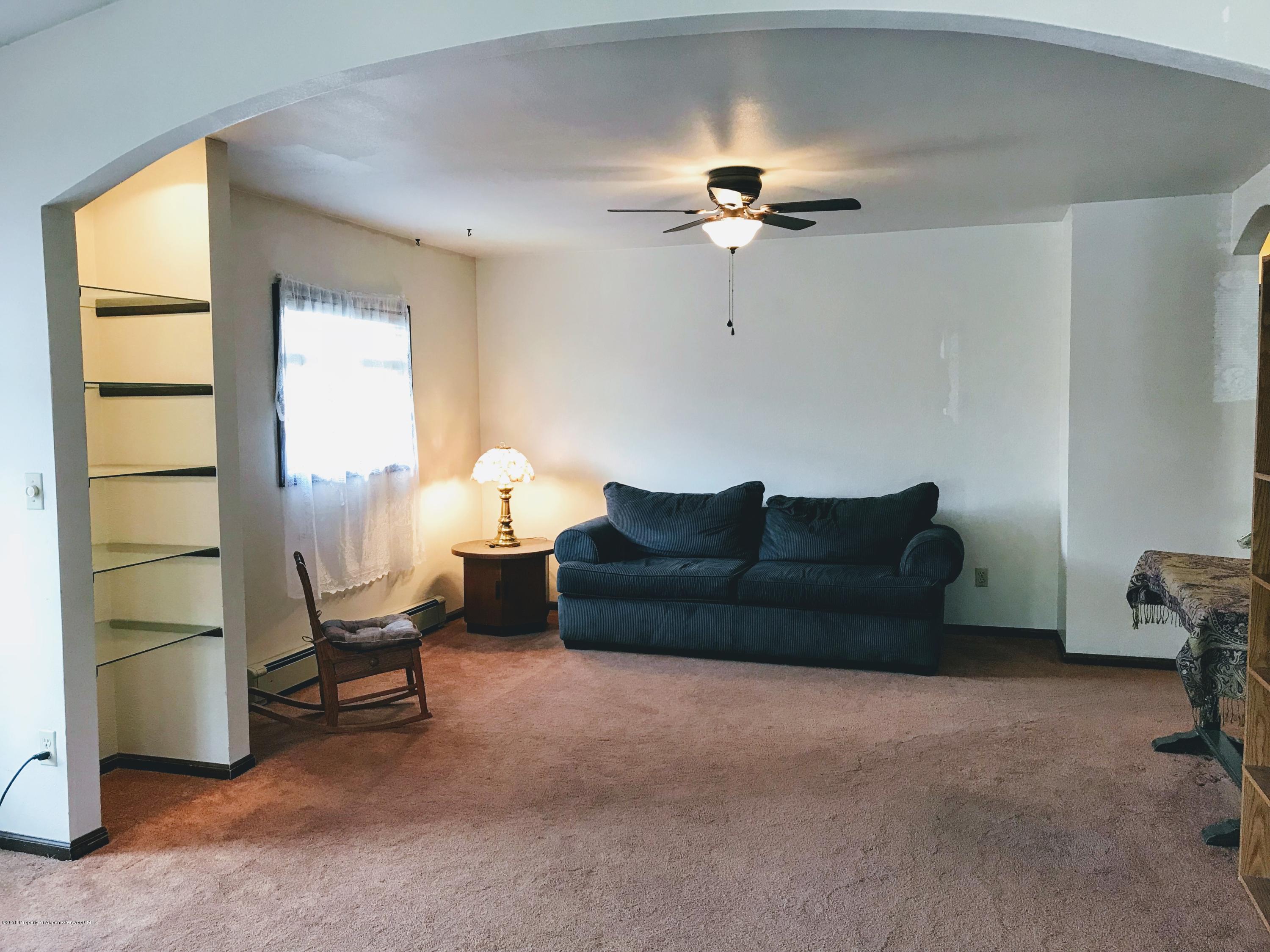 545 Ash Avenue Rifle, CO 81650 - Photo 10 of 26 a living room with furniture a chandelier and a window
