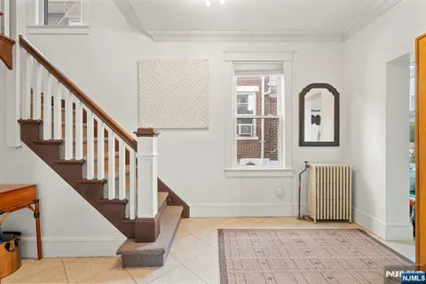 a view of entryway and hall with wooden floor