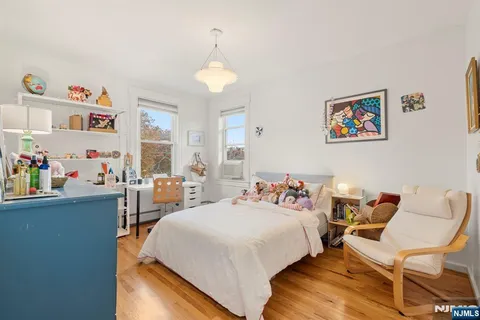 a bedroom with a bed and a desk