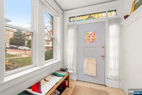 a view of an entryway with wooden floor and door