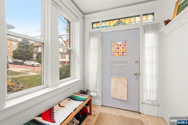 a view of an entryway with wooden floor and door