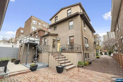 a front view of a building with parking area