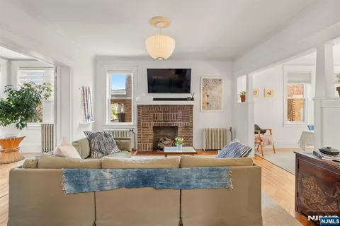 a living room with fireplace furniture and a flat screen tv