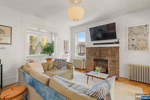 a living room with furniture fireplace and flat screen tv