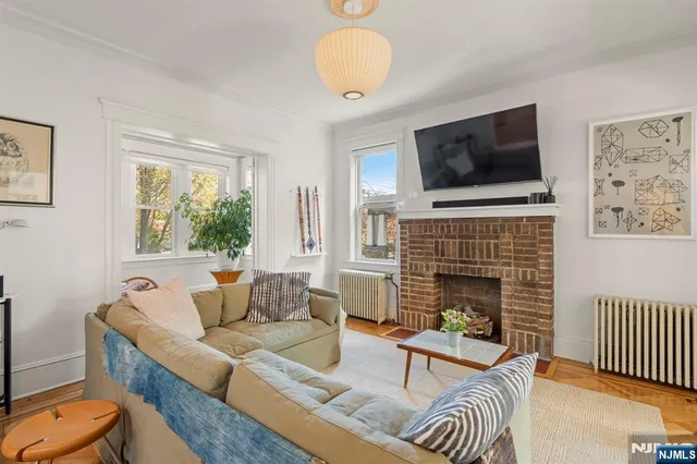 a living room with furniture fireplace and flat screen tv