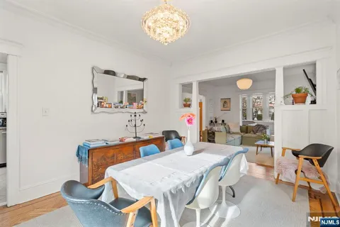 a view of a dining room with furniture and a chandelier