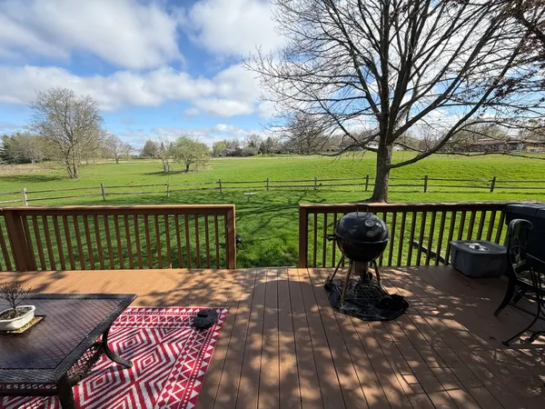 a view of a roof deck with wooden floor and fence
