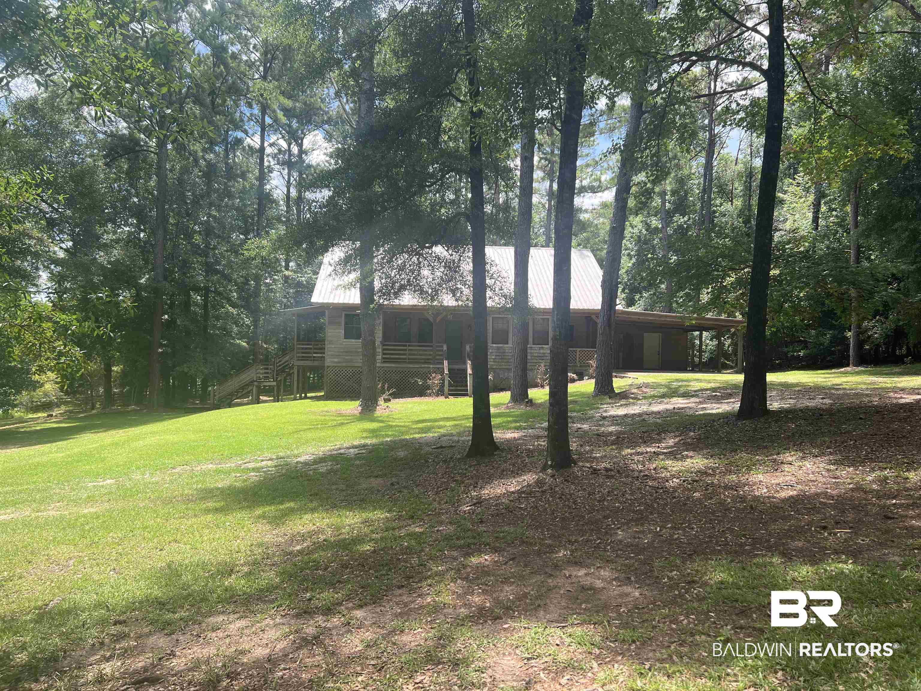 102 Brown Road Evergreen, AL 36401 - Photo 2 of 26 View of grassy yard featuring stairway and view of wooded area