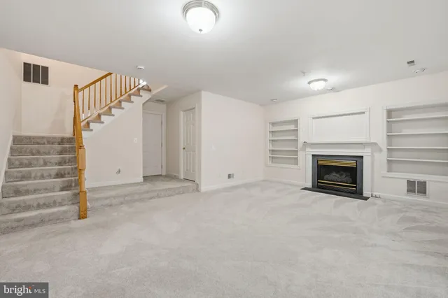 a view of an empty room with a fireplace