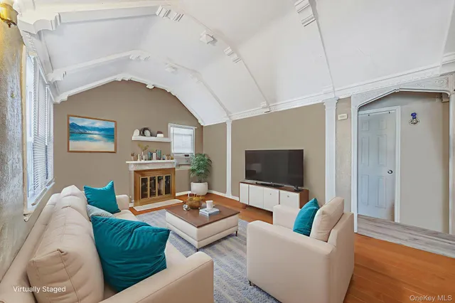 a living room with furniture a fireplace and a flat screen tv