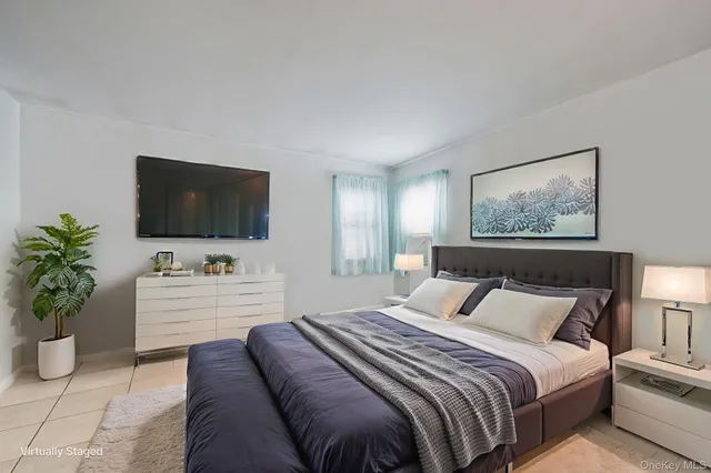 a bedroom with a bed and a flat screen television