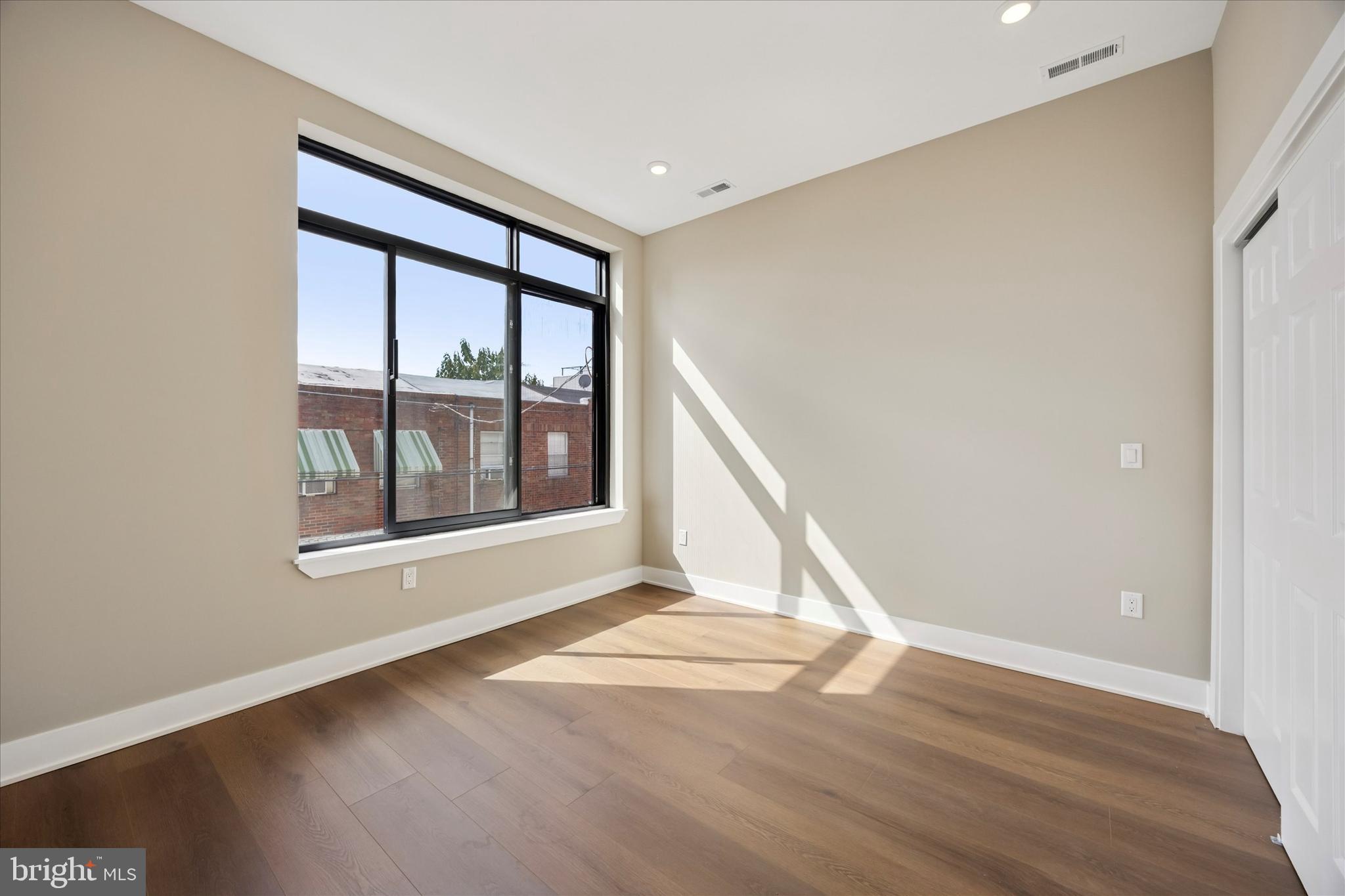 523 Gerritt Street Philadelphia, PA 19147 - Photo 20 of 35 a view of an empty room with wooden floor and a window