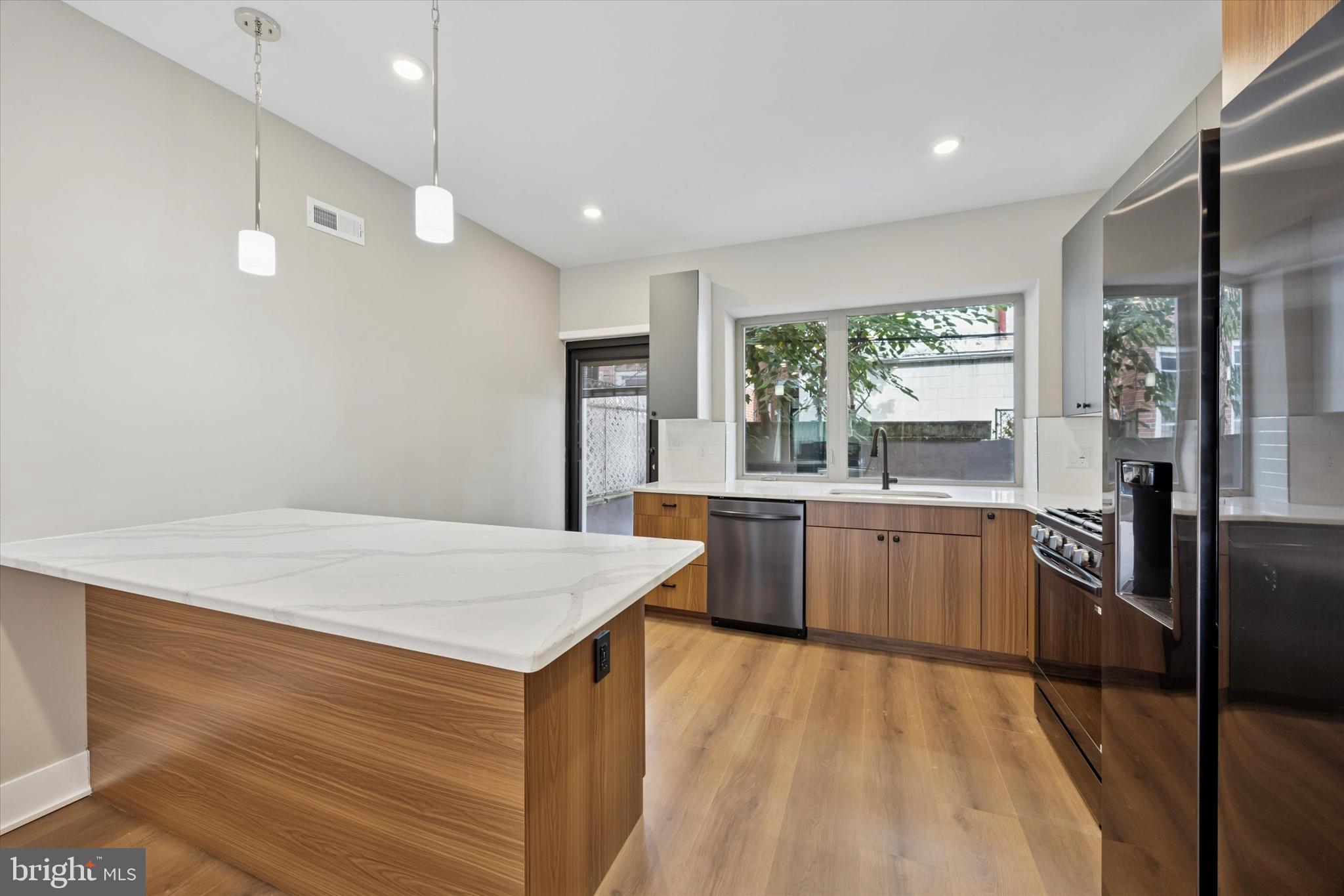 523 Gerritt Street Philadelphia, PA 19147 - Photo 5 of 35 a kitchen with a sink a stove and wooden floor
