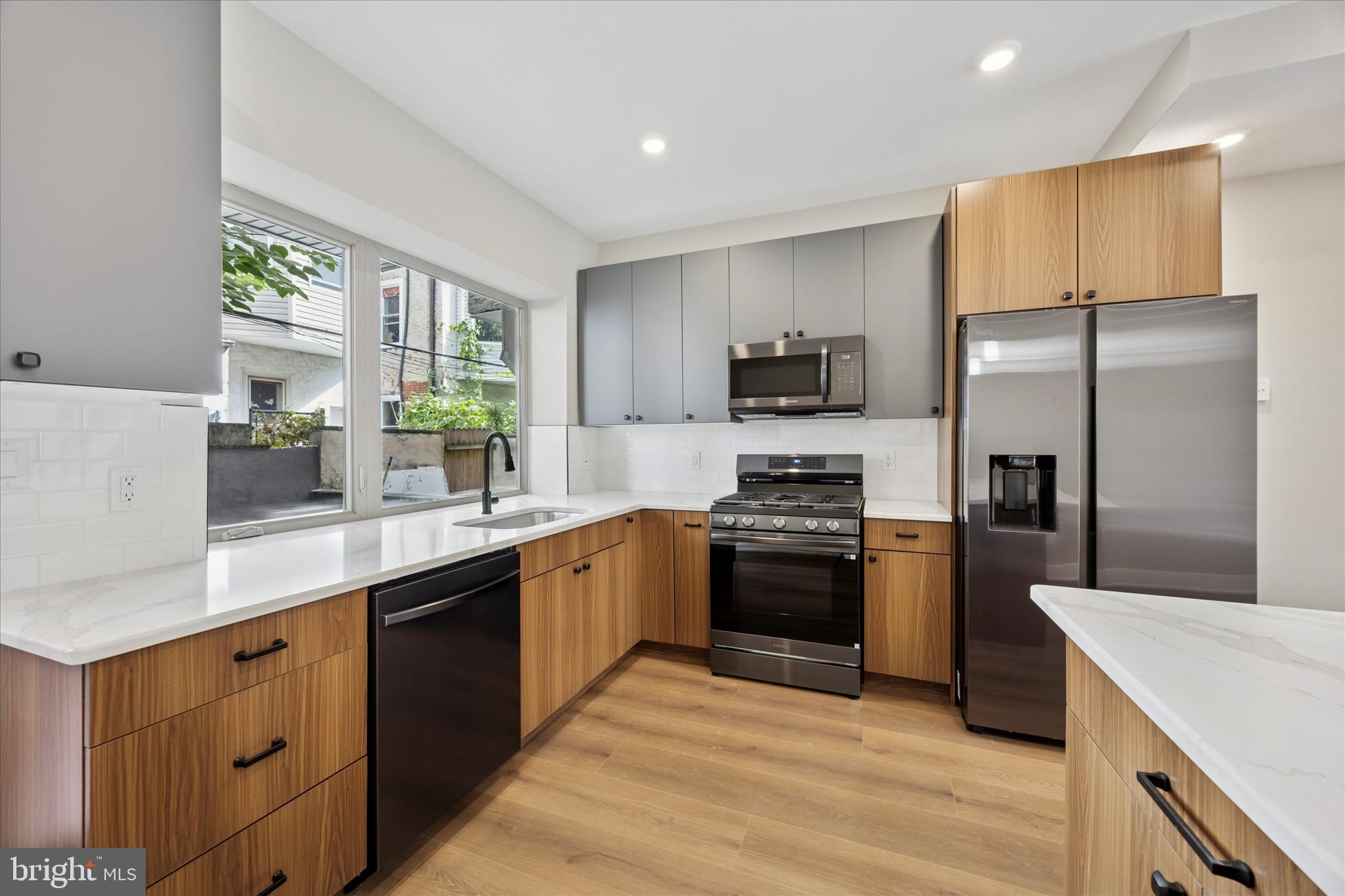 523 Gerritt Street Philadelphia, PA 19147 - Photo 7 of 35 a kitchen with stainless steel appliances granite countertop a stove a sink a refrigerator and a refrigerator
