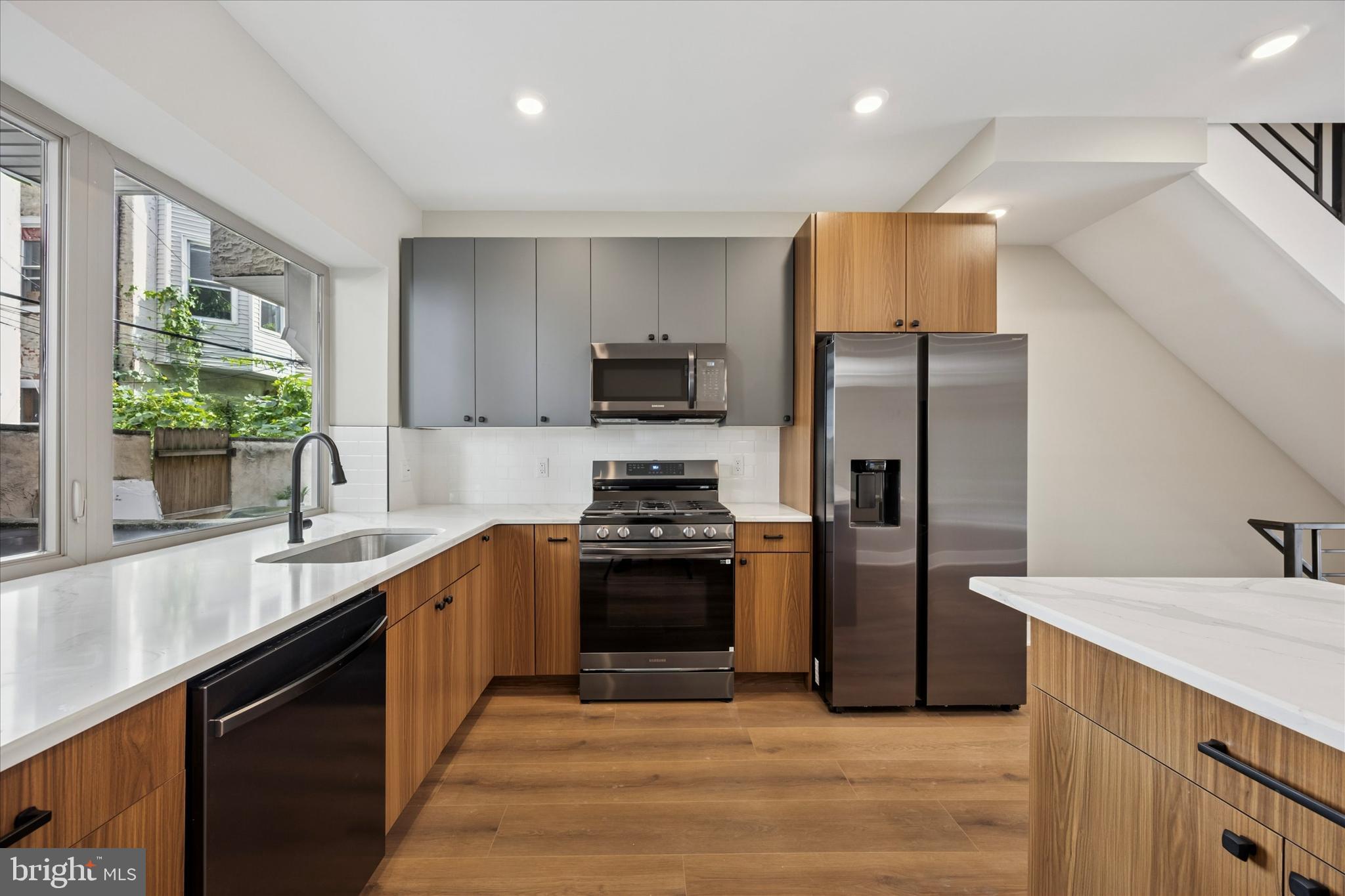 523 Gerritt Street Philadelphia, PA 19147 - Photo 8 of 35 a kitchen with stainless steel appliances granite countertop a sink stove and refrigerator