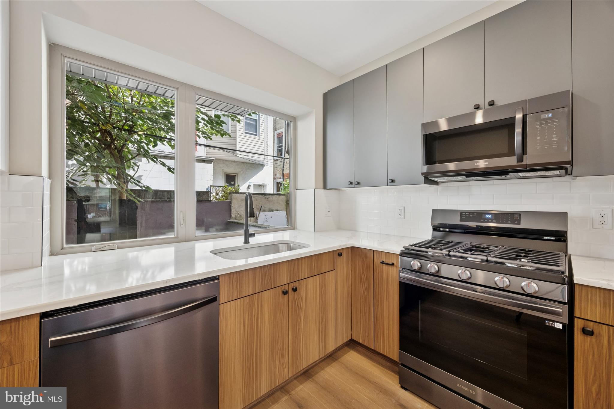 523 Gerritt Street Philadelphia, PA 19147 - Photo 9 of 35 a kitchen with a sink stove and microwave