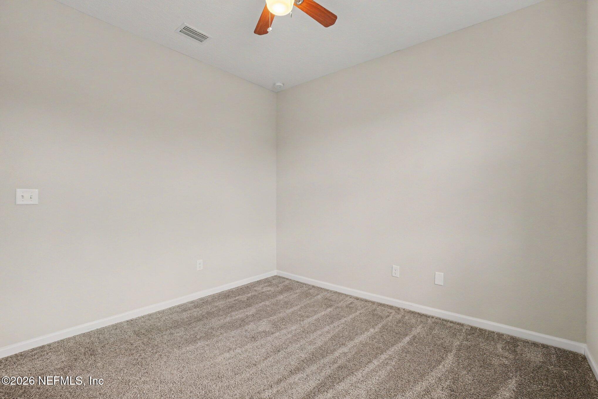4630 Pine Ridge Parkway Middleburg, FL 32068 - Photo 19 of 35 an empty room with a ceiling fan and window