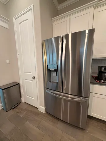 a metallic refrigerator freezer sitting in a kitchen