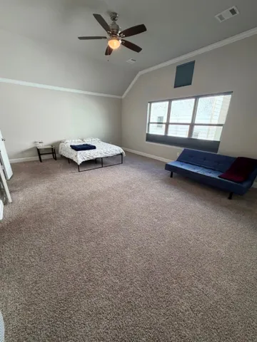 an empty room with windows and ceiling fan