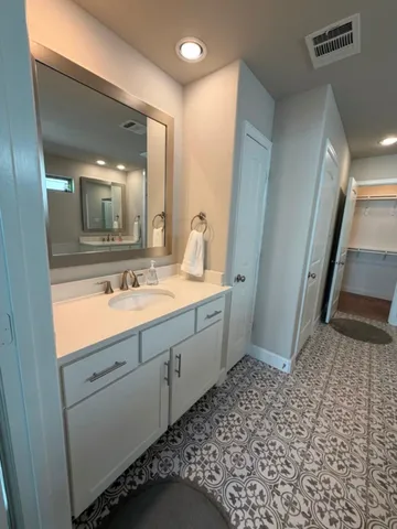 a bathroom with a double vanity sink and mirror