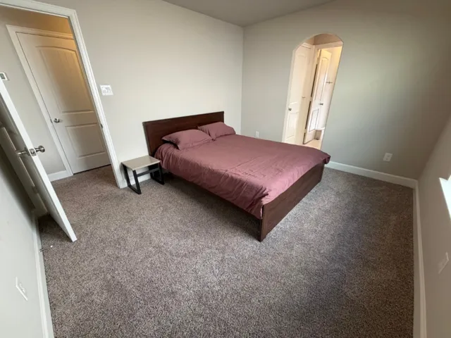 a bedroom with a bed and a mirror