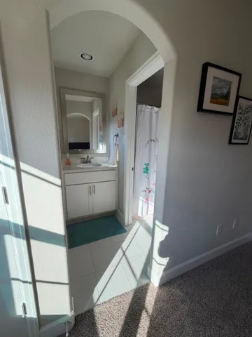 a kitchen with a refrigerator and a stove top oven