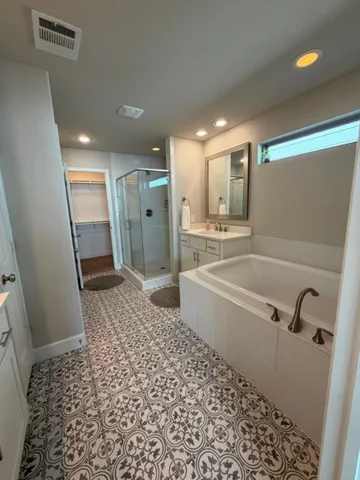 a bathroom with a bathtub and a shower