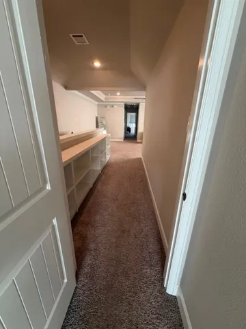 a view of a white house with a back yard