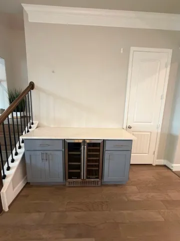 a view of an empty room with furniture and window