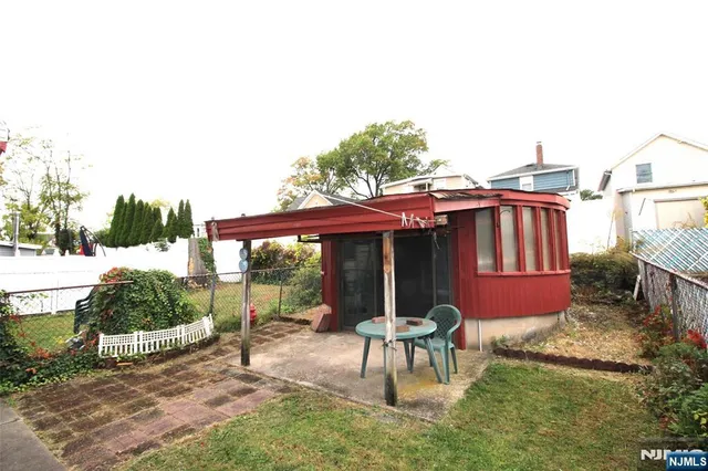 a backyard of a house with table and chairs