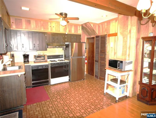 a kitchen with a sink appliances and cabinets
