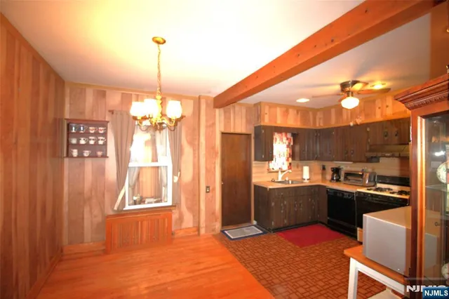a kitchen with stainless steel appliances granite countertop a refrigerator a stove and a sink
