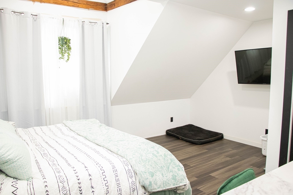 85-87 Slater Street Webster, MA 01570 - Photo 9 of 41 a bedroom with a bed and a flat screen tv