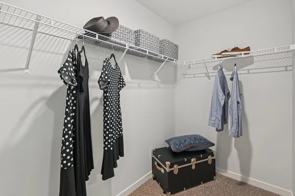 a view of walk in closet with clothes